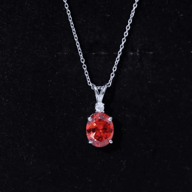 Orange sapphire oval pendant necklace with 4 carats from Rosec Jewels, featuring a silver chain and vibrant gemstone.