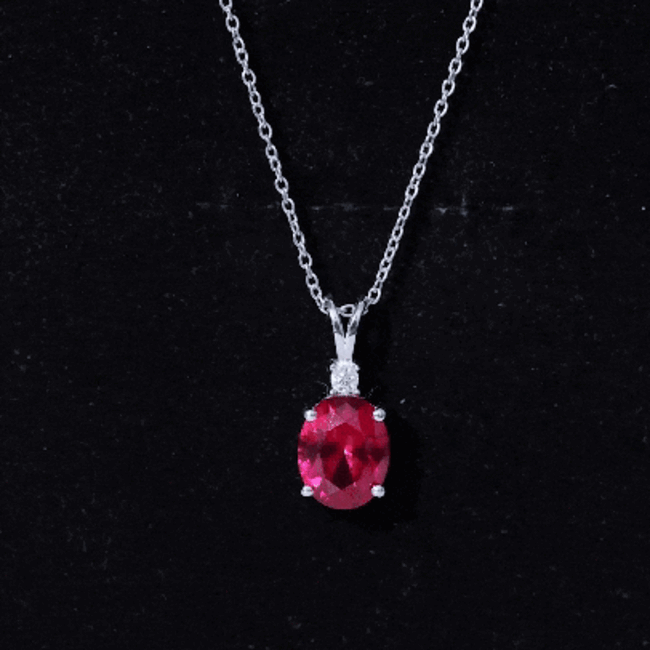 Lab-grown 4-carat ruby oval pendant necklace with silver chain by Rosec Jewels, showcasing a sparkling gemstone.