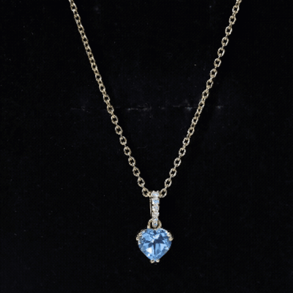 Yellow gold heart pendant featuring a 0.9 carat Swiss Blue Topaz solitaire and diamond accents on a chain.