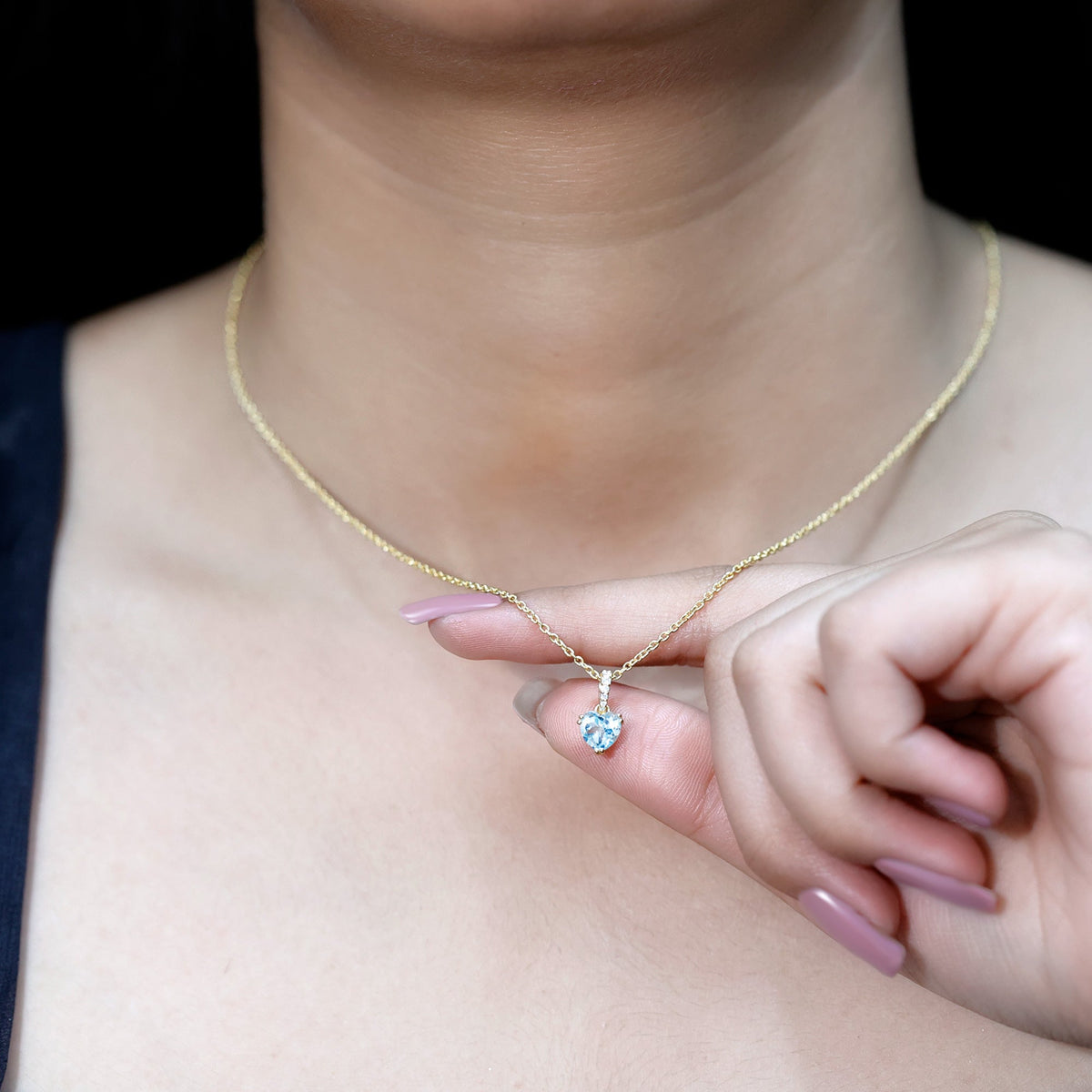 Swiss blue topaz solitaire and diamond heart pendant on a chain, elegant jewelry piece by Rosec Jewels.