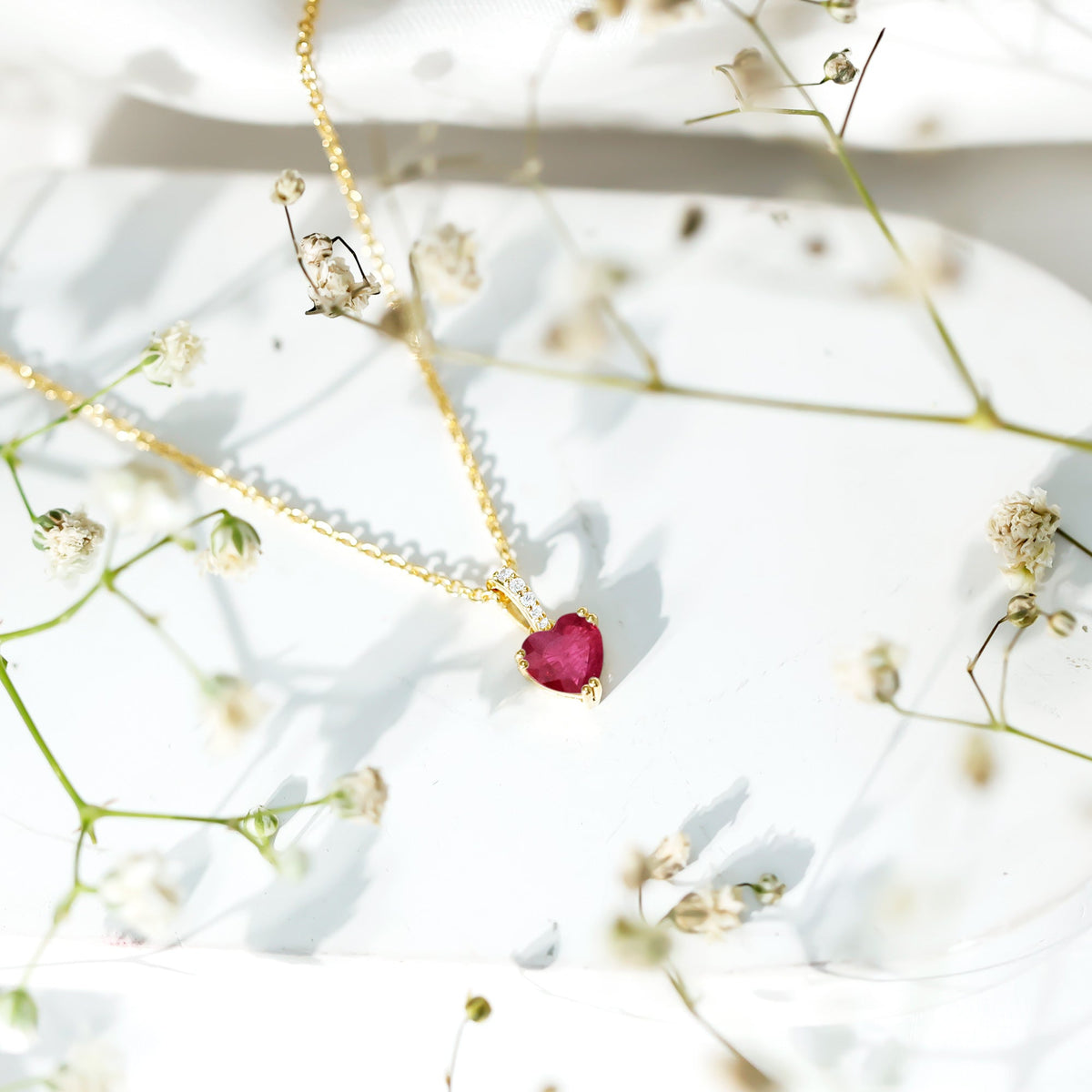 Natural 1 carat ruby heart pendant with diamond bail by Rosec Jewels, showcasing a sparkling ruby heart and elegant pendant design.