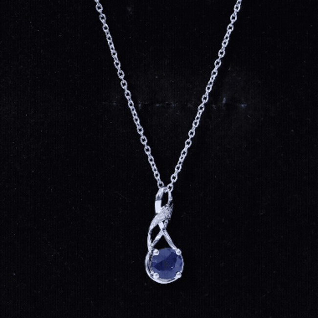 Natural 1 Carat blue sapphire infinity pendant on silver chain, elegant jewelry with a sparkling blue gemstone.