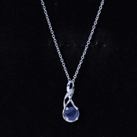 Natural 1 Carat blue sapphire infinity pendant on silver chain, elegant jewelry with a sparkling blue gemstone.