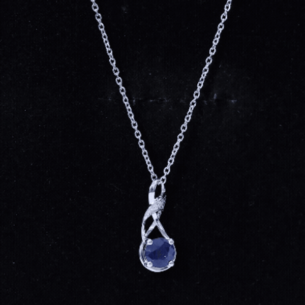 Natural 1 Carat blue sapphire infinity pendant on silver chain, elegant jewelry with a sparkling blue gemstone.