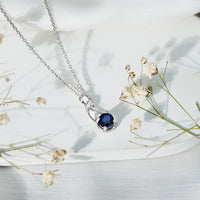 Natural 1 Carat Blue Sapphire Infinity Necklace pendant with silver chain from Rosec Jewels, showcasing a sparkling blue sapphire infinity design.