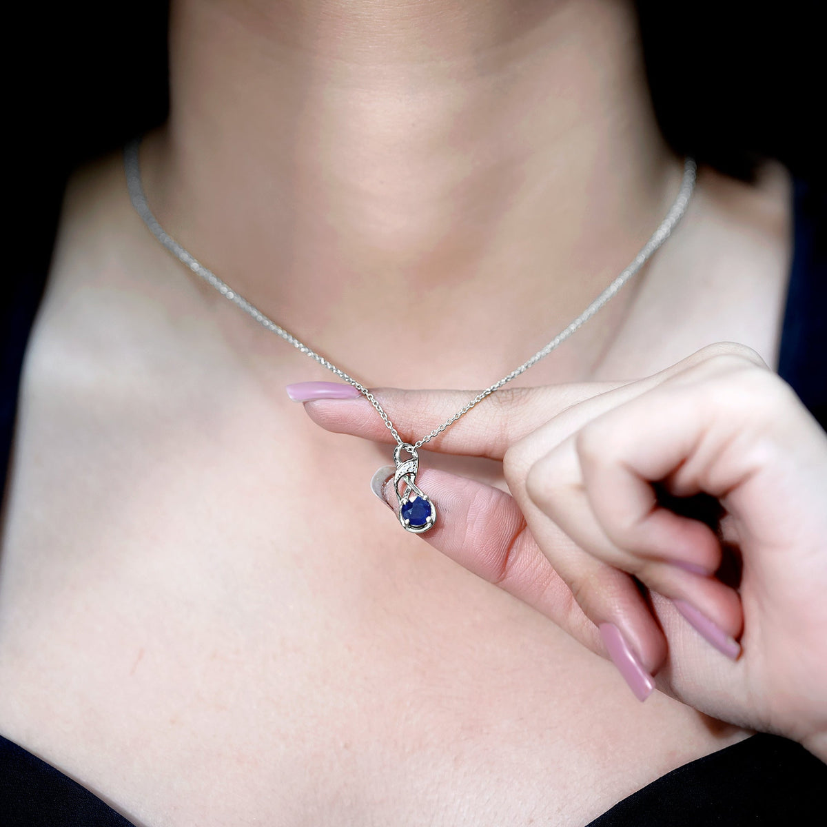 Natural 1 carat blue sapphire infinity pendant on silver chain, elegant jewelry by Rosec Jewels.