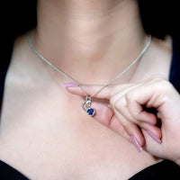 Natural 1 carat blue sapphire infinity pendant on silver chain, elegant jewelry by Rosec Jewels.