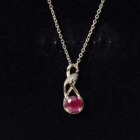 Natural 1.5 carat ruby and diamond infinity pendant necklace with a silver chain by Rosec Jewels.