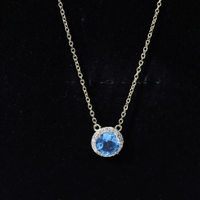 Yellow gold pendant necklace featuring a 1.5 carat Swiss Blue Topaz with a diamond halo, crafted by Rosec Jewels.