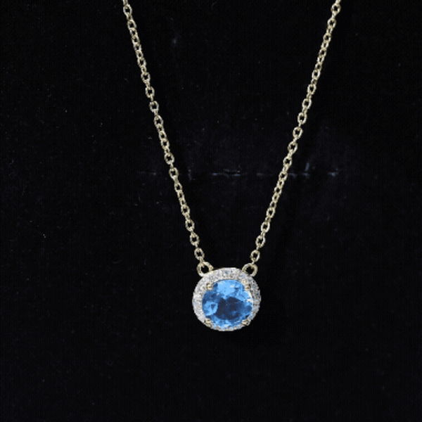 Yellow gold pendant necklace featuring a 1.5 carat Swiss Blue Topaz with a diamond halo, crafted by Rosec Jewels.
