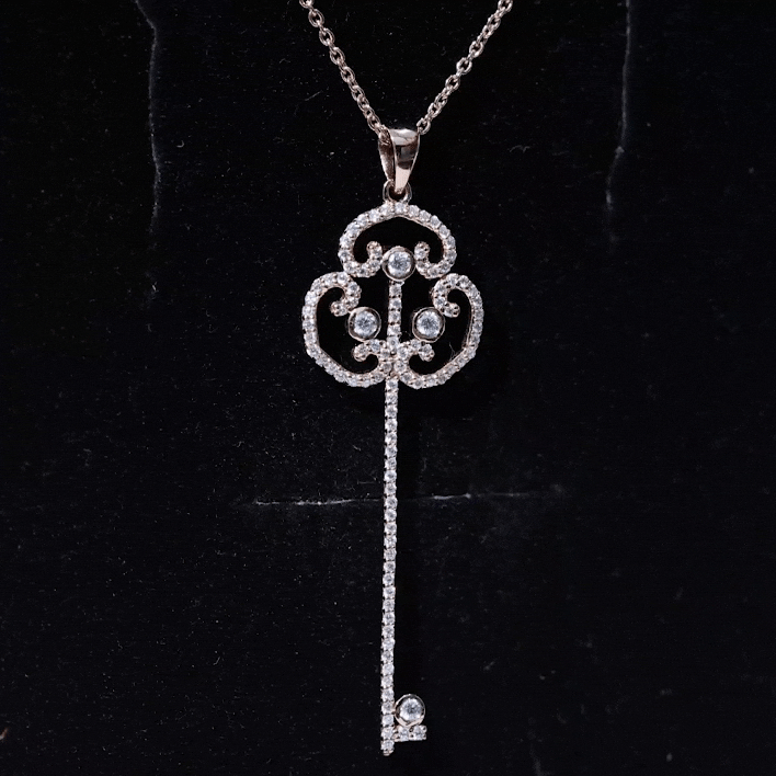 Vintage Moissanite key pendant necklace by Rosec Jewels featuring a sparkling white moissanite gemstone and intricate metalwork.