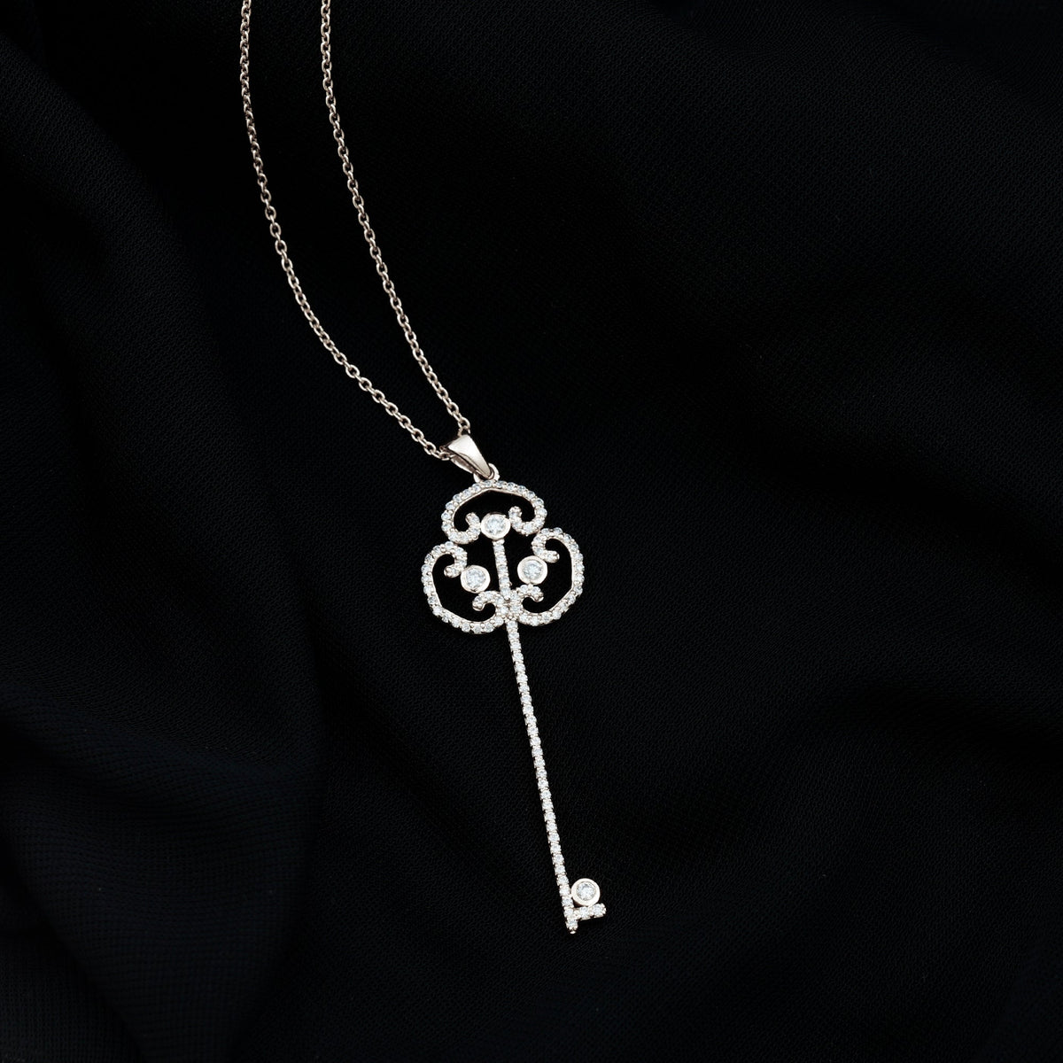 Vintage moissanite key pendant necklace by Rosec Jewels featuring a sparkling moissanite stone on a delicate chain.