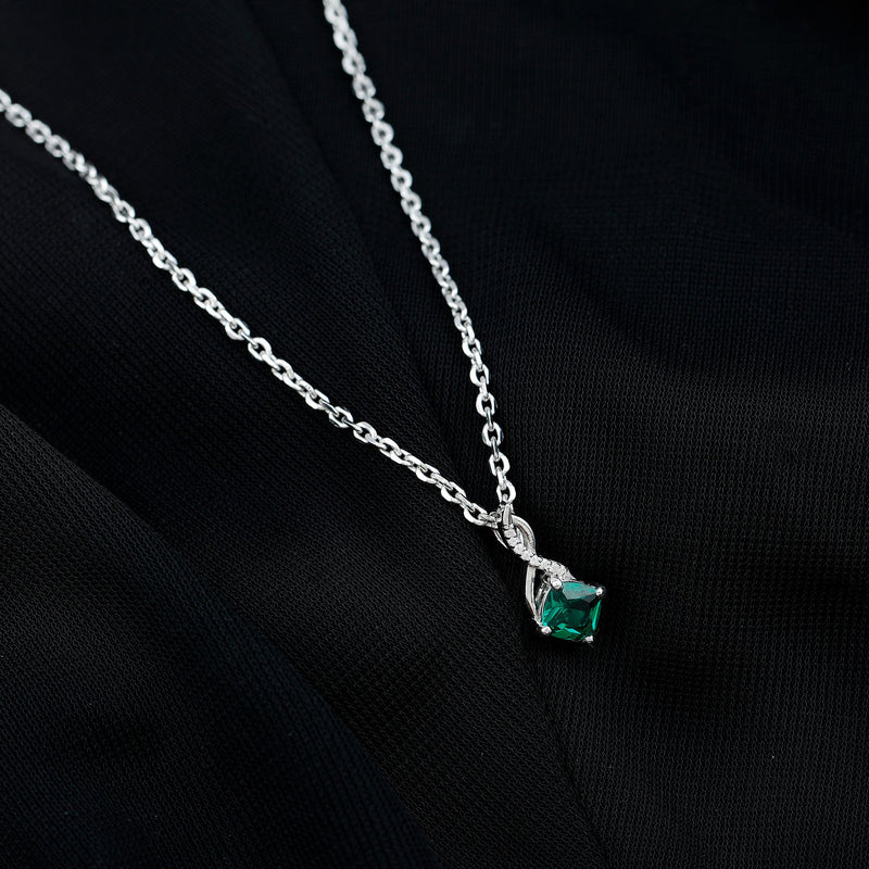 Cushion cut lab-created emerald infinity pendant on silver chain, featuring a 0.9 carat emerald gemstone and elegant jewelry design