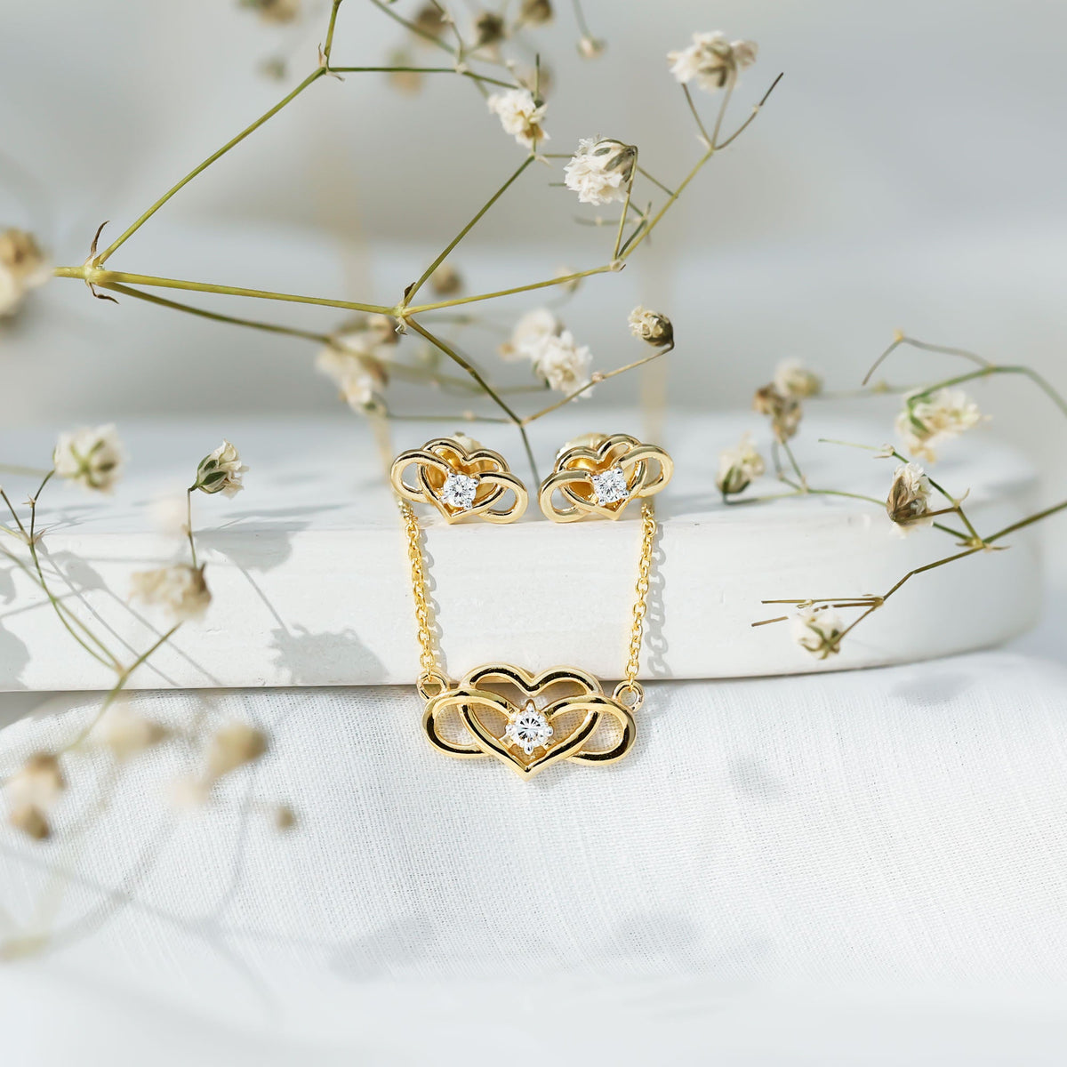 Round cut diamond infinity heart jewelry set by Rosec Jewels featuring sparkling diamond accents and elegant design.
