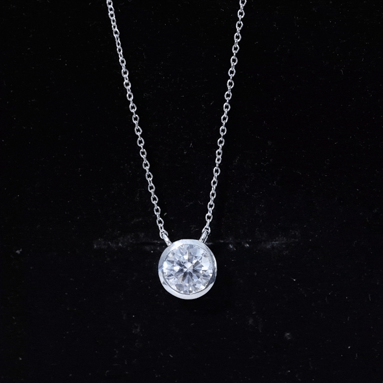 Bezel set 1.36 carat round moissanite pendant in silver necklace featuring a sparkling gemstone and elegant design.