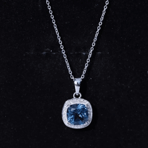 Yellow cushion cut 2.8 carat London Blue Topaz pendant with diamond halo, showcasing elegant jewelry design.