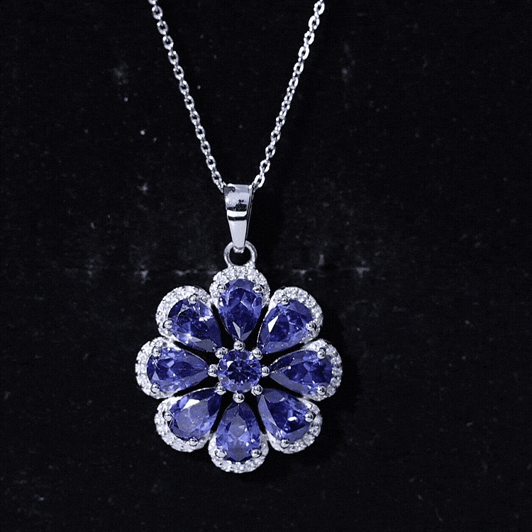 Lab-created blue sapphire flower pendant with moissanite halo, featuring a delicate gold chain from Rosec Jewels.