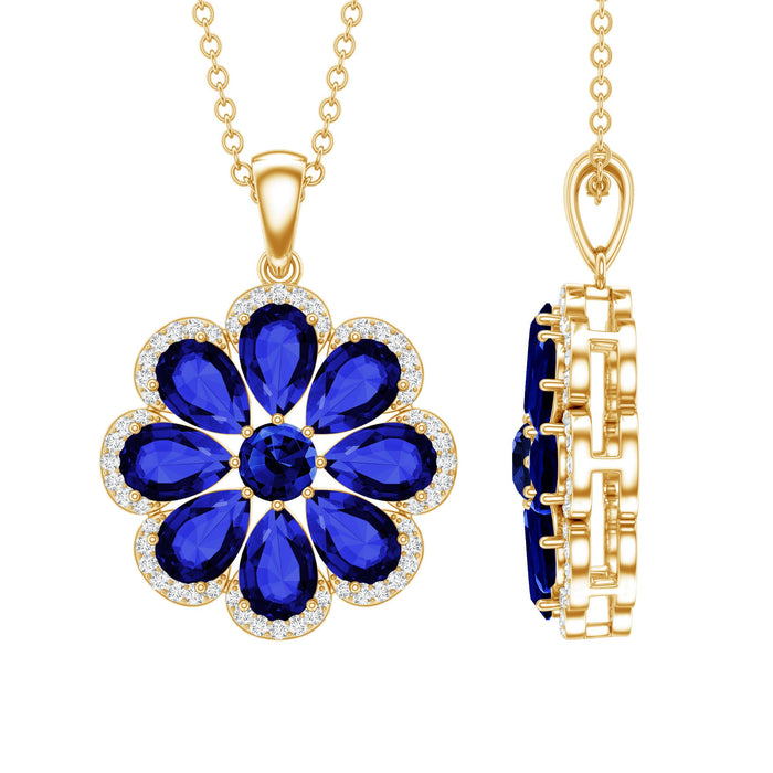 Lab-created blue sapphire flower pendant necklace with moissanite halo, featuring a delicate floral design and sparkling gemstone accents.