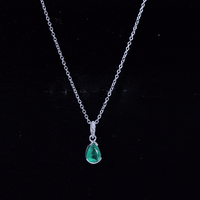 Pear cut emerald solitaire pendant with diamond accent bail, showcasing a elegant green gemstone necklace by Rosec Jewels.
