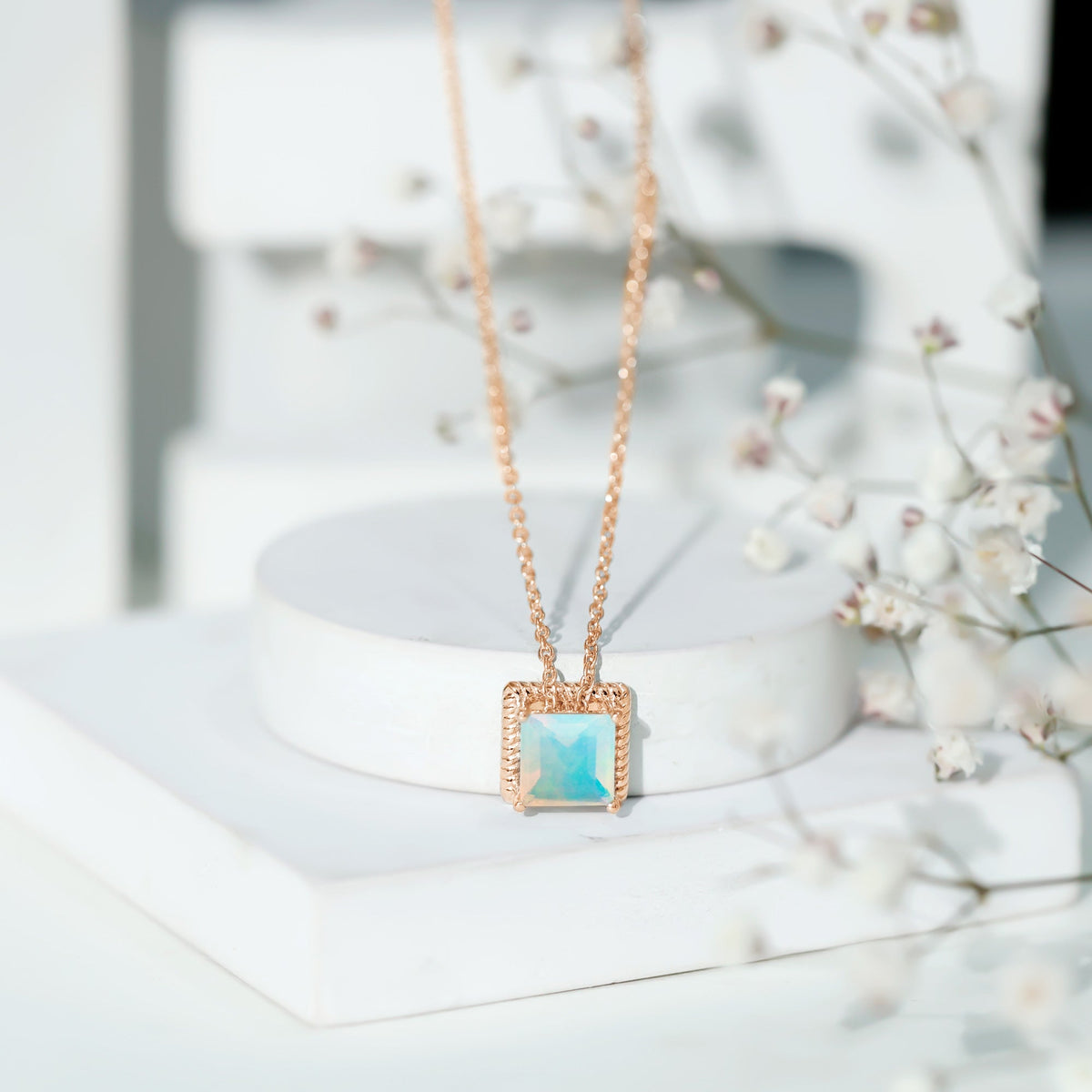 Ethiopian opal solitaire necklace with 2-carat princess cut stone in a rope frame, featuring a delicate chain from Rosec Jewels.