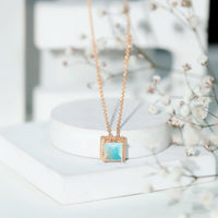 Ethiopian opal solitaire necklace with 2-carat princess cut stone in a rope frame, featuring a delicate chain from Rosec Jewels.