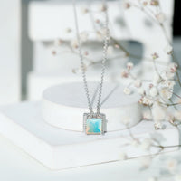 Ethiopian opal solitaire necklace with 2 carat princess cut stone in a rope frame, from Rosec Jewels.