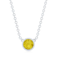Round cut 4mm yellow sapphire pendant bezel set in a necklace by Rosec Jewels with a delicate chain.