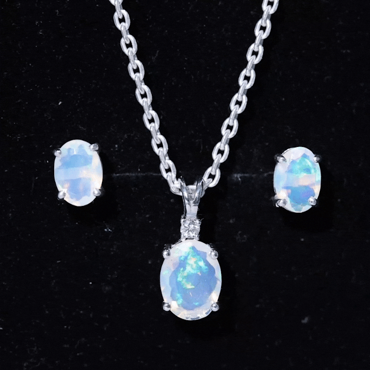 Real 3 Carat Ethiopian Opal solitaire necklace and earrings set with diamonds, featuring oval-shaped opals and elegant jewelry design.