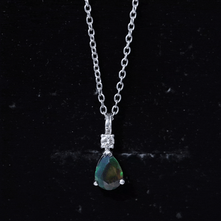 Pear-shaped black opal drop pendant with a diamond accent from Rosec Jewels, showcasing a sleek yellow gemstone on a delicate chain.