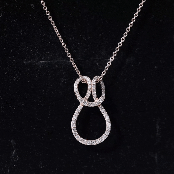 Yellow gold lab grown diamond infinity love knot pendant for women by Rosec Jewels, showcasing a sparkling love knot design.