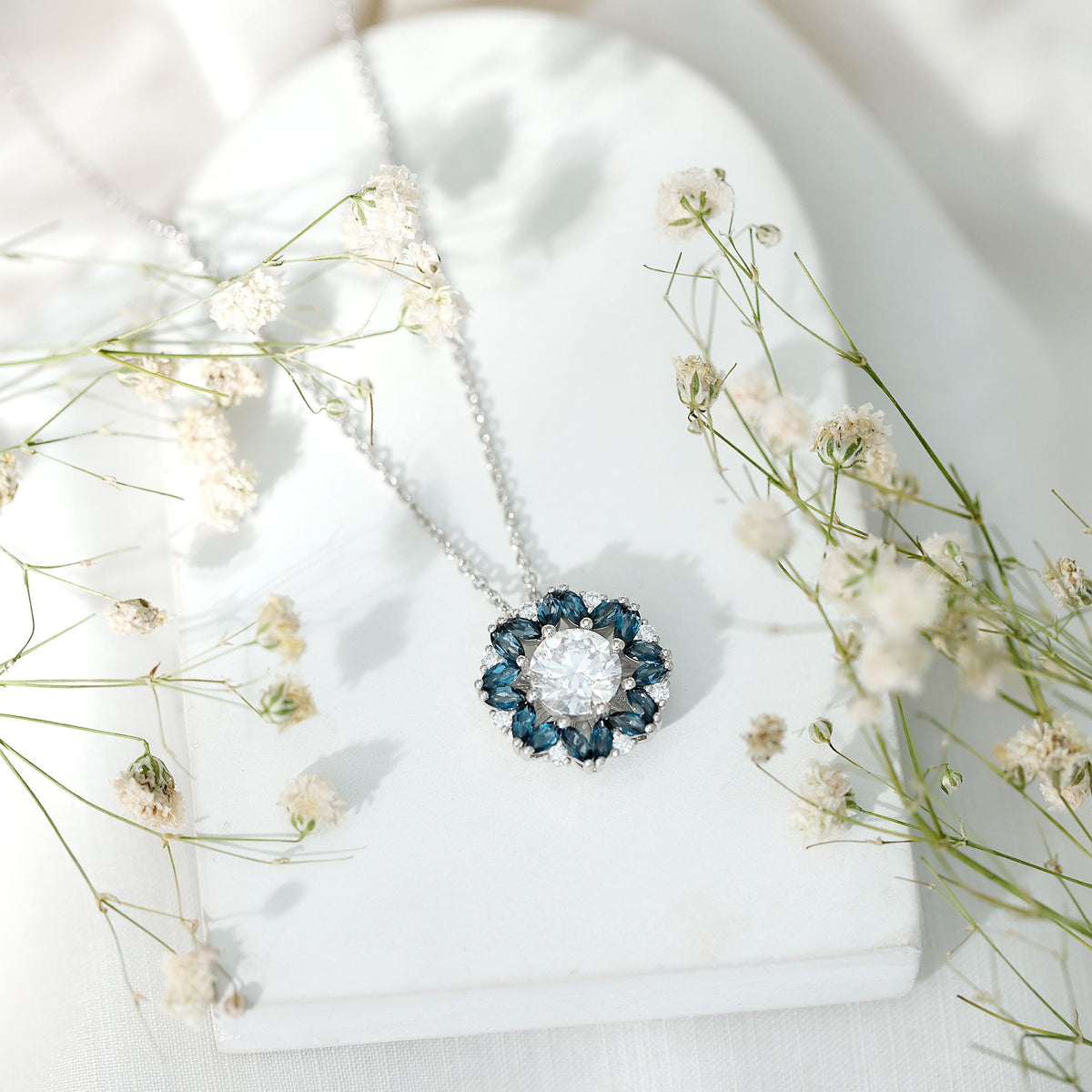 Rosec Jewels 2 Carat Moissanite statement necklace with a London Blue Topaz halo pendant, showcasing a sparkling gemstone design.