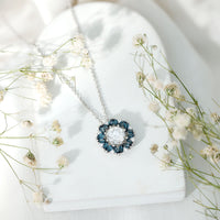 Rosec Jewels 2 Carat Moissanite statement necklace with a London Blue Topaz halo pendant, showcasing a sparkling gemstone design.