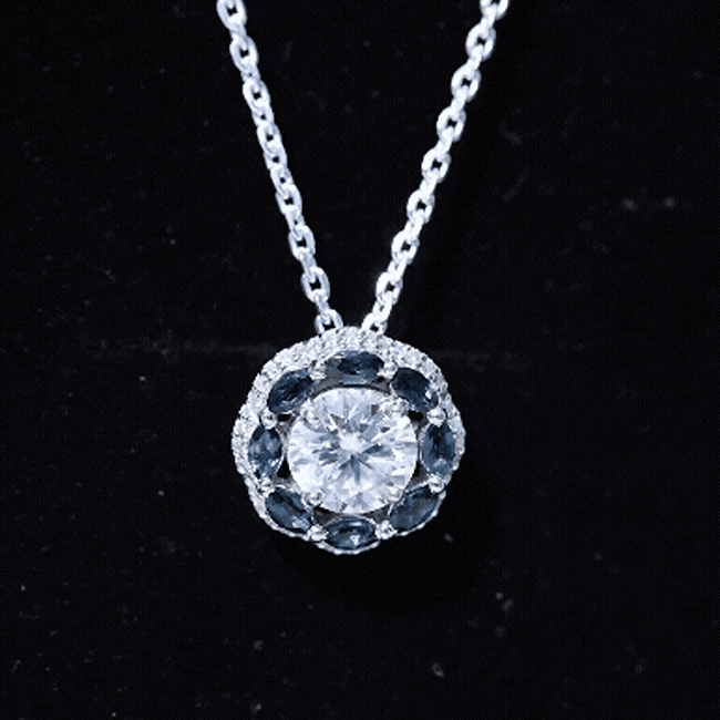 Silver flower pendant necklace with a 2 carat moissanite and London Blue Topaz gemstone, from Rosec Jewels.
