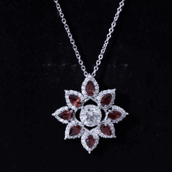 Yellow gold flower pendant with certified moissanite and garnet stones, elegant jewelry piece from Rosec Jewels.