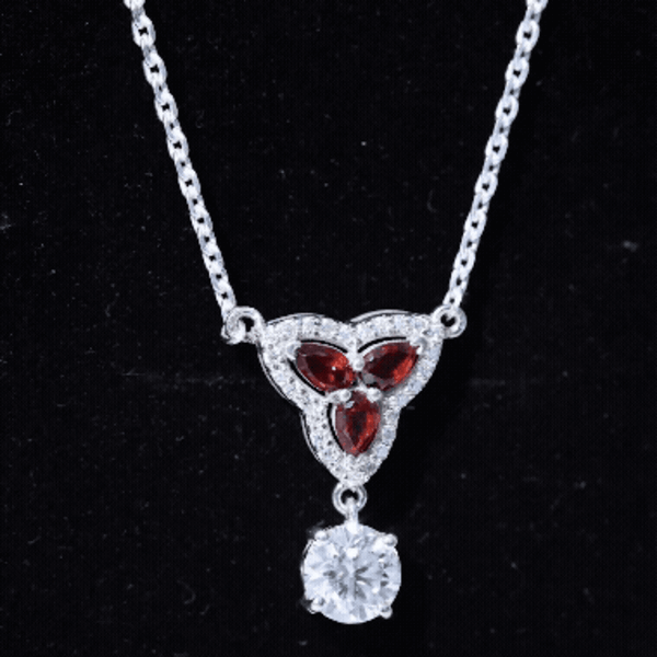 Silver bridal pendant necklace featuring certified Moissanite and garnet stones, designed by Rosec Jewels.