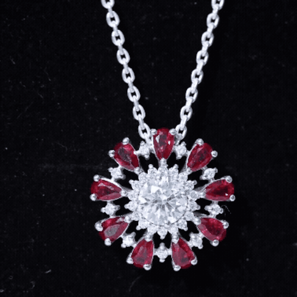 Elegant rose gold flower pendant necklace with a 1.3 carat moissanite and lab-grown ruby center stone, from Rosec Jewels.