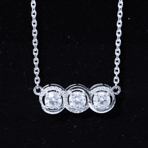 Three-stone moissanite pendant necklace with silver chain from Rosec Jewels, showcasing sparkling round stones and elegant design.