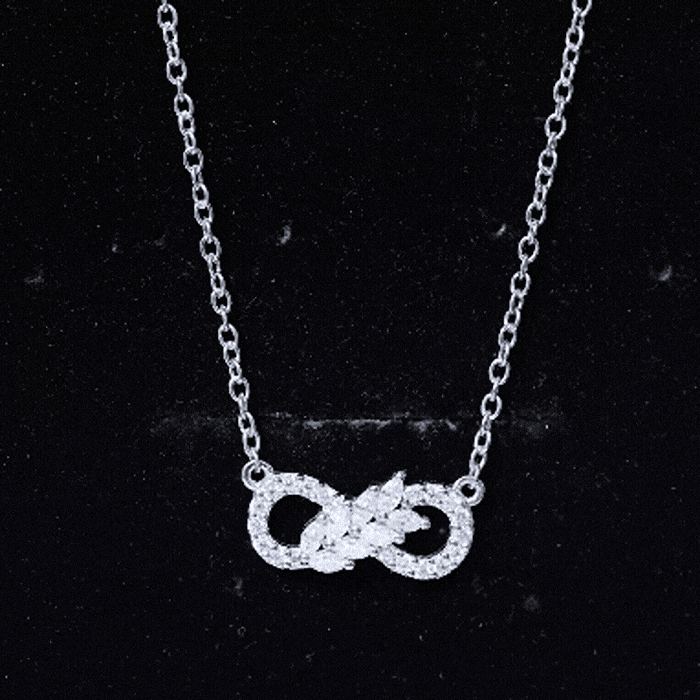 Sterling silver moissanite infinity pendant necklace with sparkling white stones, designed by Rosec Jewels.