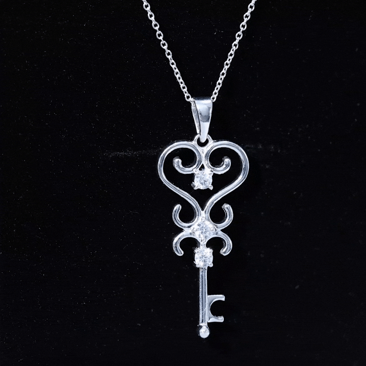 Vintage-inspired cubic zirconia key pendant necklace by Rosec Jewels featuring a sparkling white zirconia stone and detailed design.
