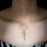 Vintage-inspired cubic zirconia key pendant necklace by Rosec Jewels, featuring sparkling stones and a detailed design.