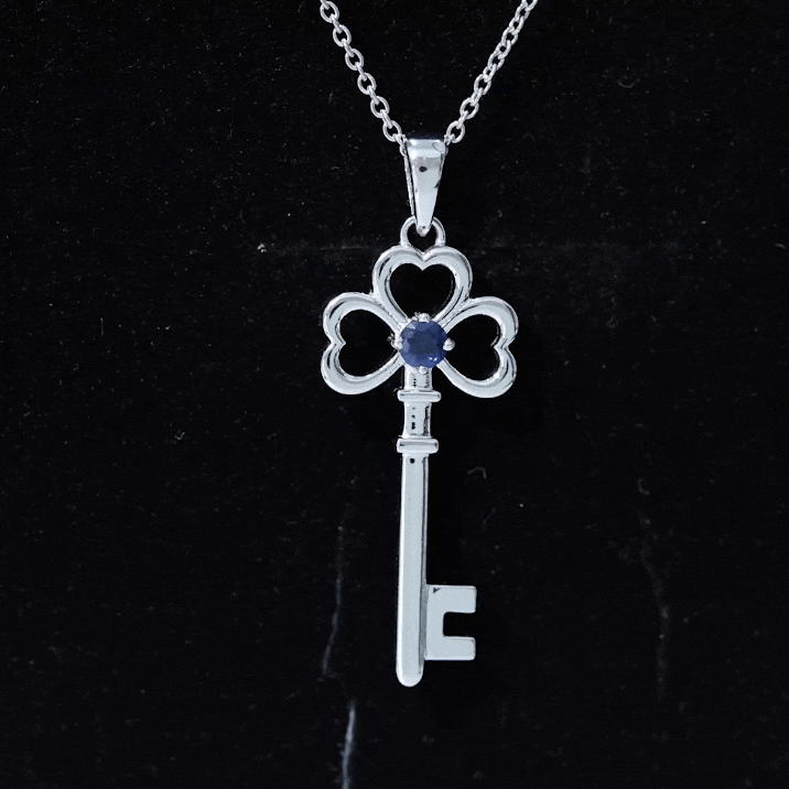 Yellow pendant necklace with a natural blue sapphire heart-shaped charm, featuring a delicate chain from Rosec Jewels.