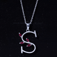 Lab grown ruby and diamond pendant necklace featuring a letter S from Rosec Jewels, with yellow gold setting and intricate design.