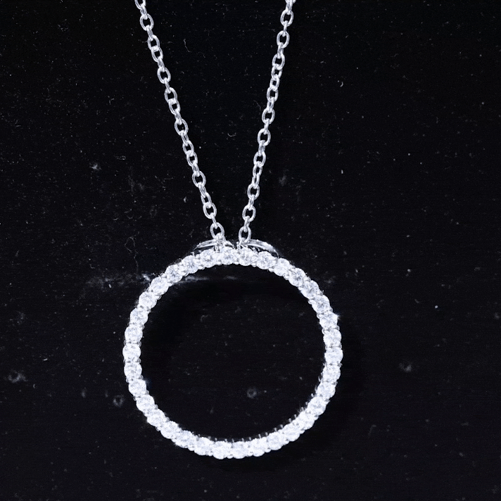 Silver chain necklace with a circular pendant featuring sparkling cubic zirconia stones, from Rosec Jewels.