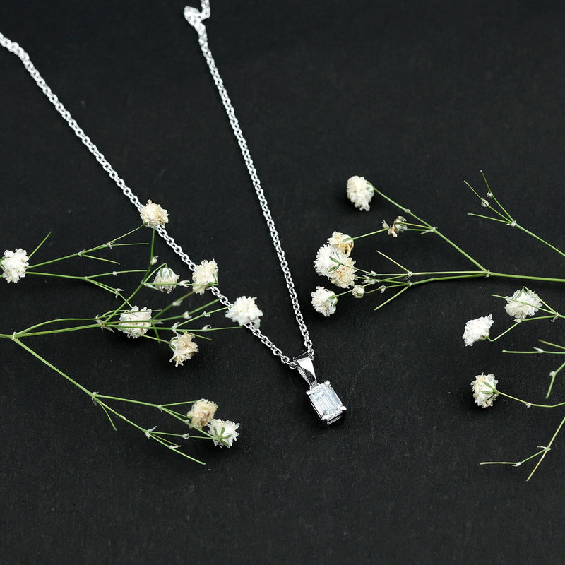 Emerald cut cubic zirconia solitaire pendant with silver chain, showcased on a white background, from Rosec Jewels.