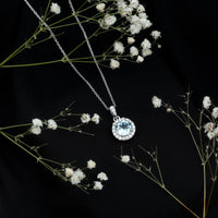 Round cut 2 carat sky blue topaz pendant necklace with silver chain, showcasing a sparkling blue gemstone on a sleek silver pendant.