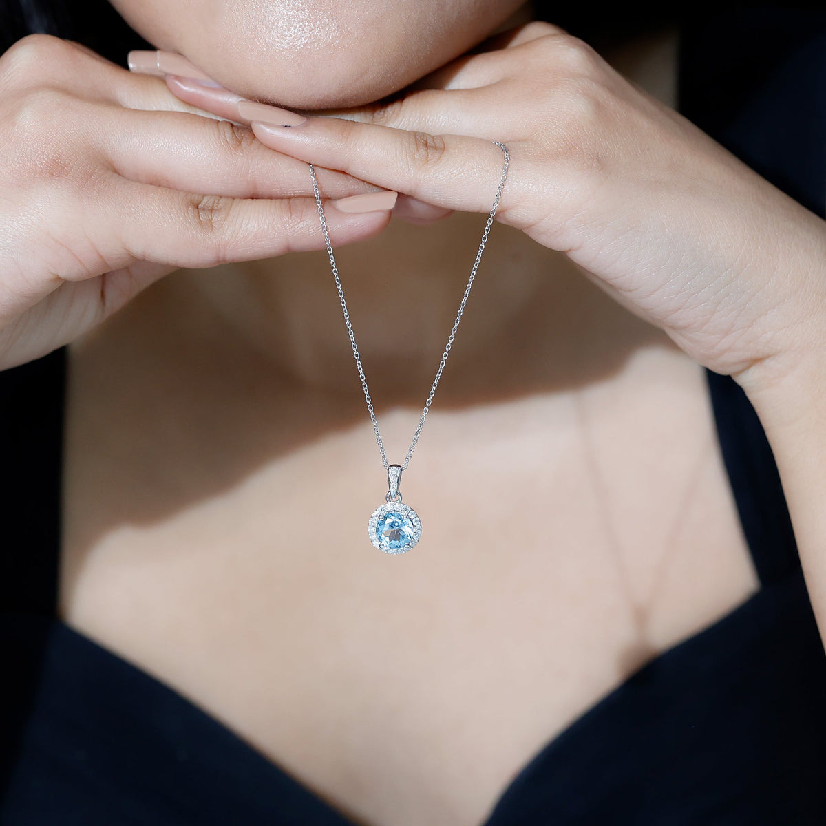 Round cut 2 carat sky blue topaz pendant necklace with silver chain by Rosec Jewels, featuring a sparkling blue gemstone centerpiece.