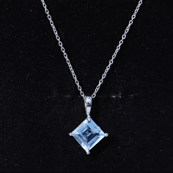 Princess cut sky blue topaz solitaire pendant with silver chain, featuring a 3-carat gemstone on a delicate silver necklace.
