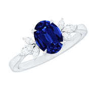 Oval lab-grown blue sapphire engagement ring with diamond trio setting from Rosec Jewels, showcasing sparkling stones and sleek band.
