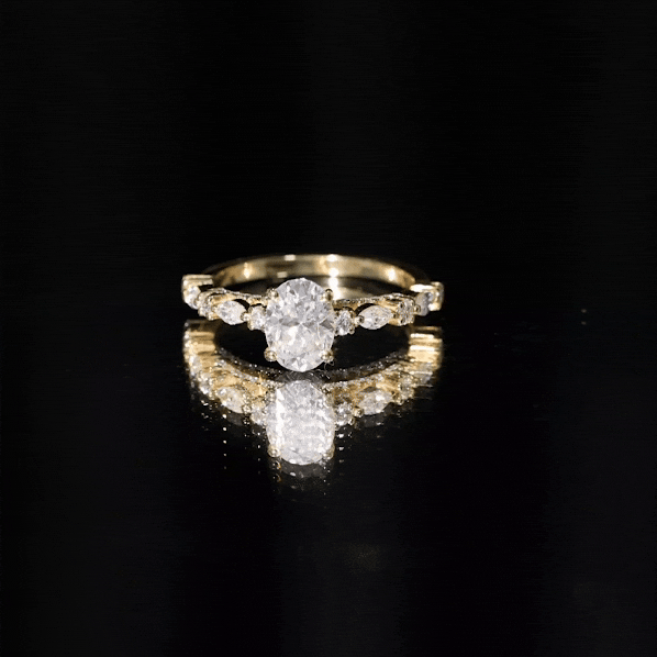 Oval moissanite solitaire engagement ring in a claw setting with a polished band, showcasing elegant jewelry craftsmanship.
