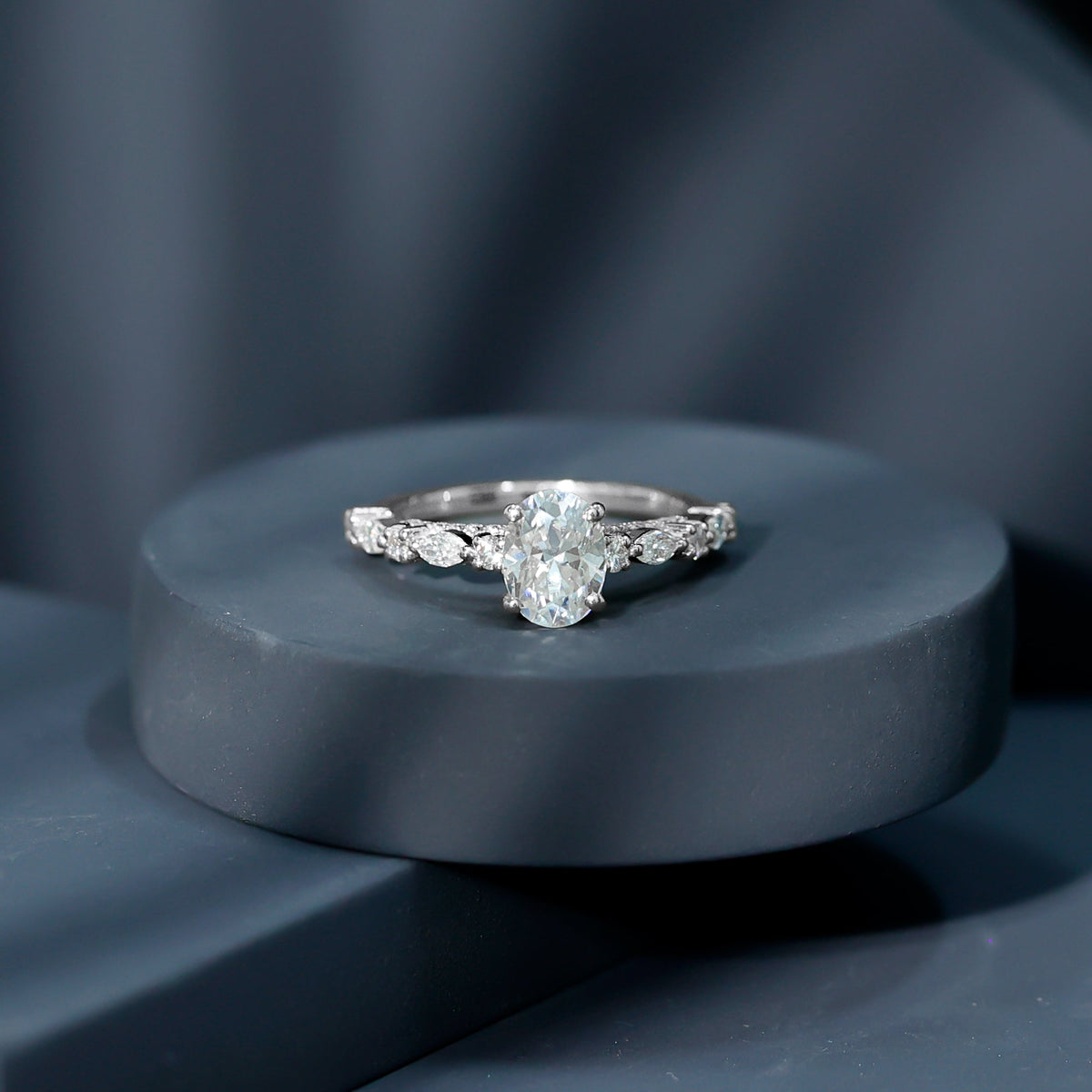 Oval moissanite solitaire engagement ring in a claw setting, featuring a sparkling center stone and elegant band from Rosec Jewels.